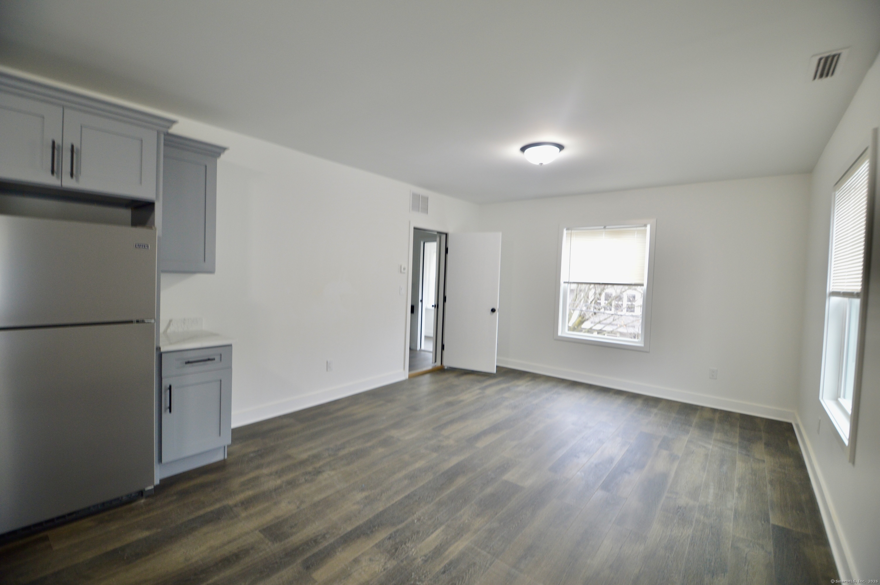21 Nichols Street Ansonia, CT 06401 - Photo 5 of 21 a view of an empty room with a window and wooden floor