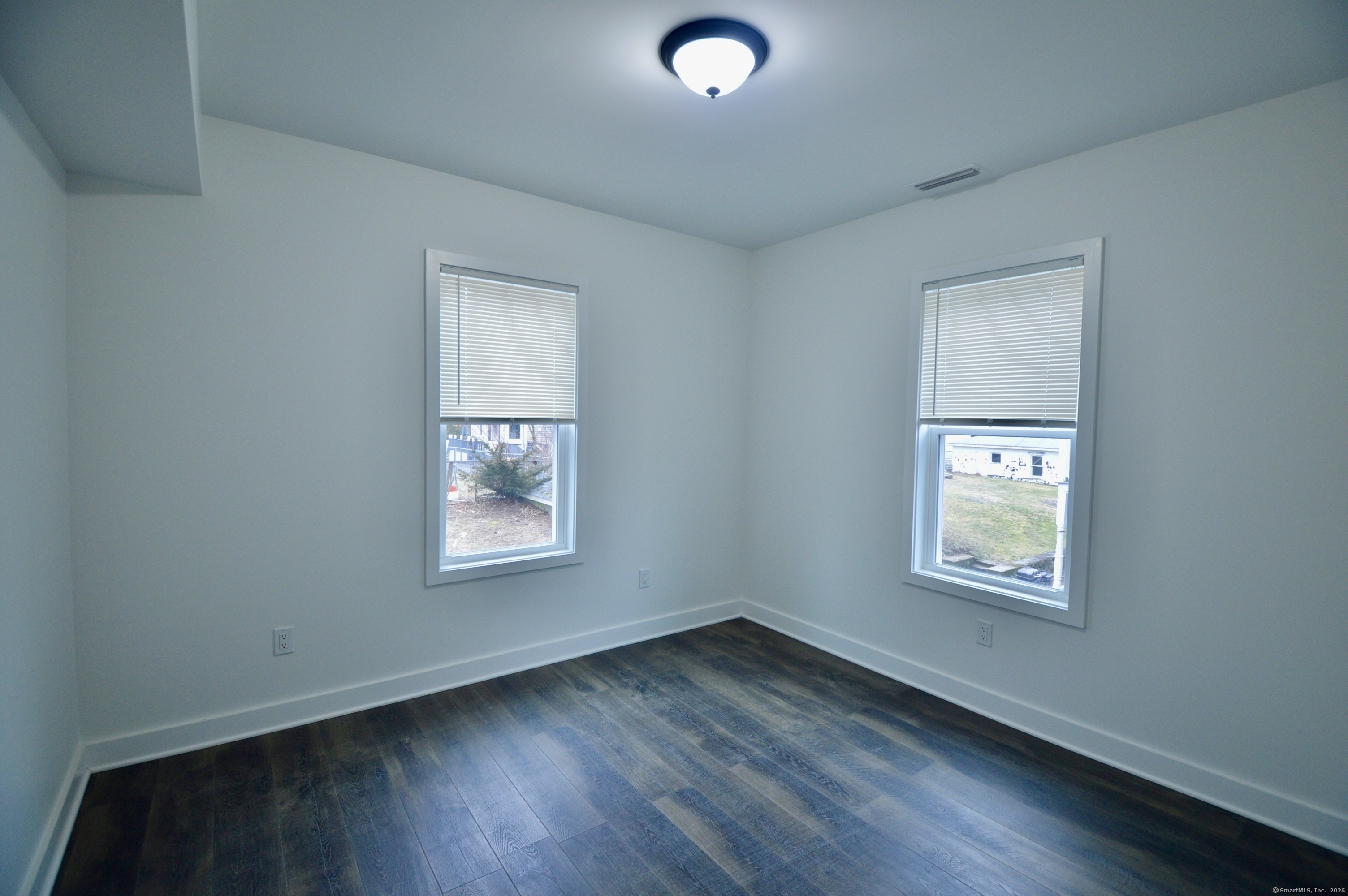 21 Nichols Street Ansonia, CT 06401 - Photo 7 of 21 an empty room with wooden floor and a window