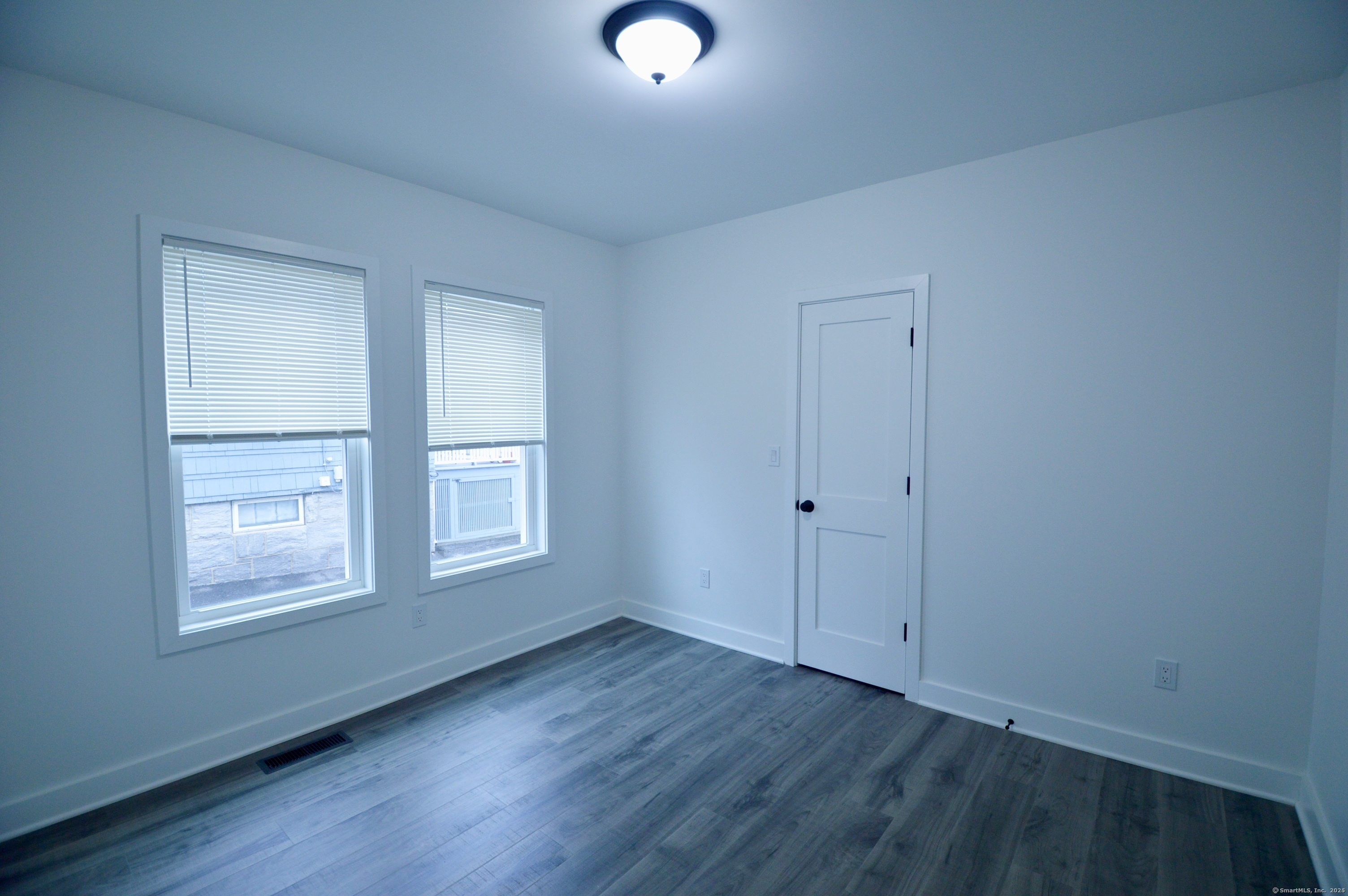 21 Nichols Street Ansonia, CT 06401 - Photo 8 of 21 an empty room with wooden floor and windows