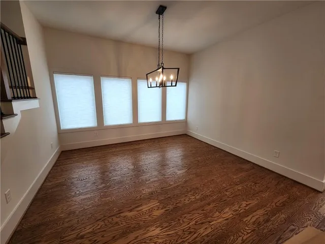 a view of a room with wooden floor and windows