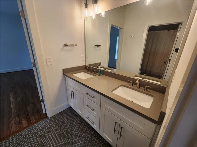 a bathroom with a double vanity sink and mirror