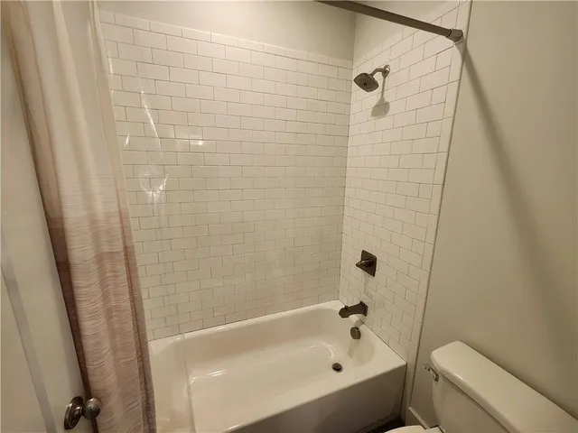 a bathroom with a bathtub and a toilet