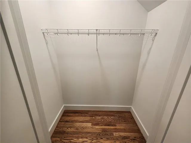 a view of walk in closet with empty racks