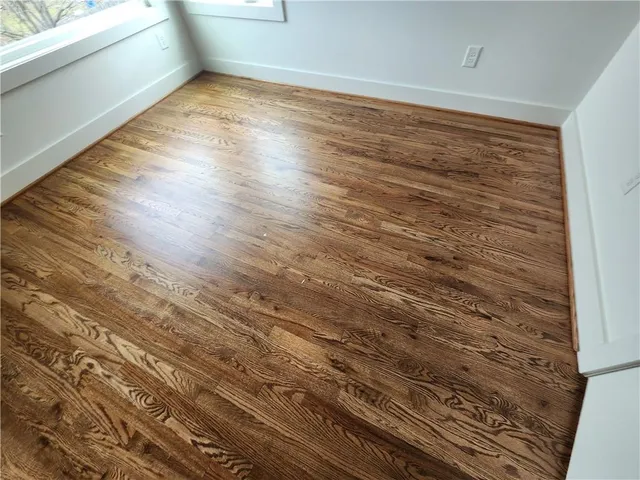 a view of wooden floor and windows in a room