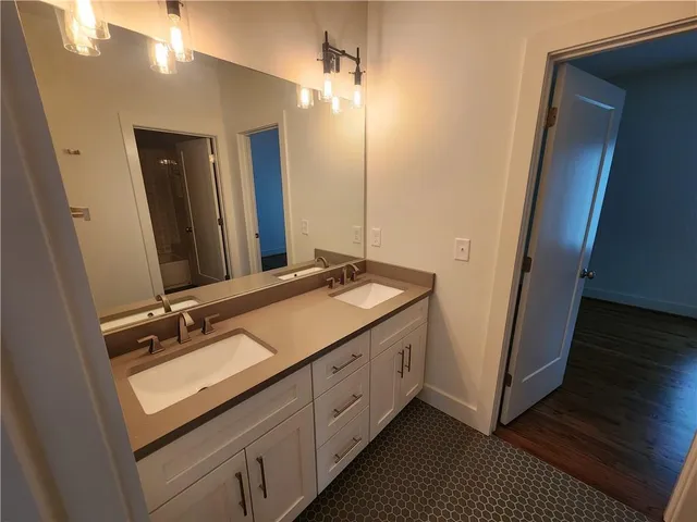 a bathroom with a double vanity sink and mirror