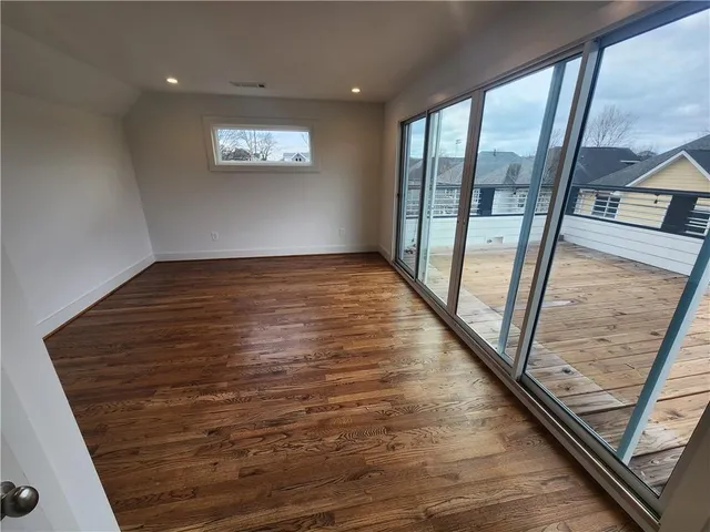 a view of a balcony with wooden floor