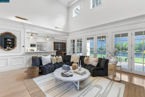 a kitchen with granite countertop a sink appliances cabinets and furniture