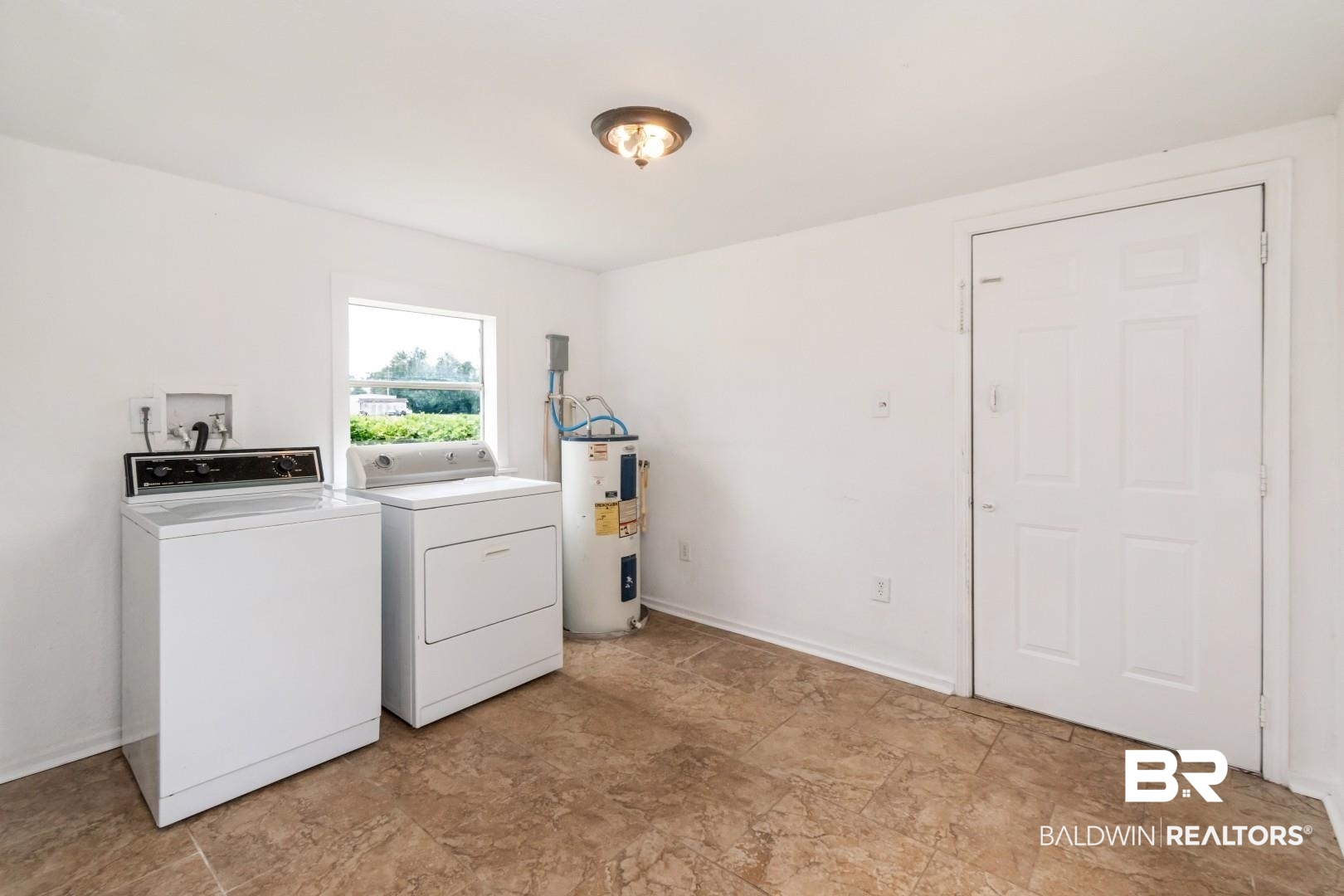 2905A McFarland Road, Unit F Mobile, AL 36695 - Photo 19 of 29 Utility space featuring durable tile flooring and a window providing natural illumination