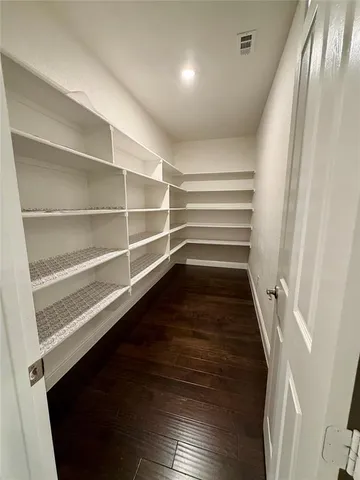 a view of walk in closet with empty racks