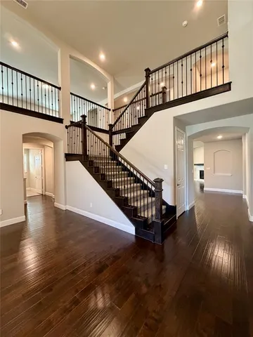 a view of staircase with lots of frames and a flower garden
