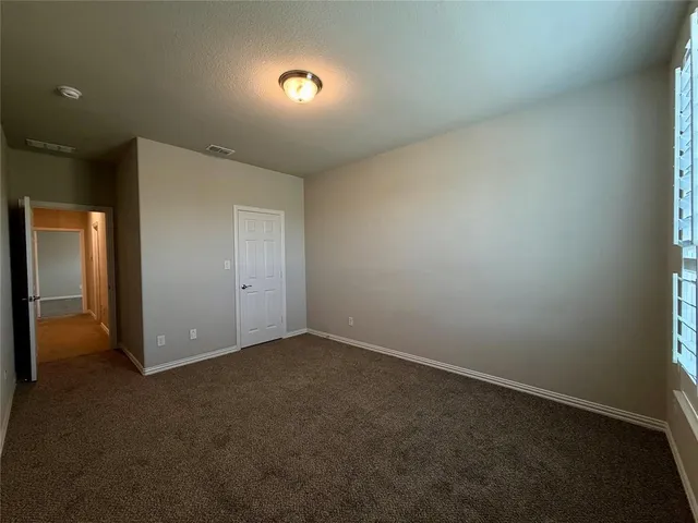 a large white kitchen with a sink and dishwasher a stove top oven with white cabinets