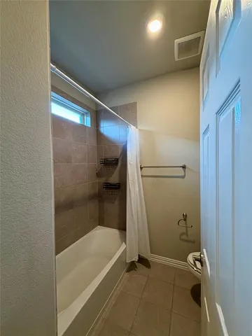 an empty room with closet and a chandelier fan