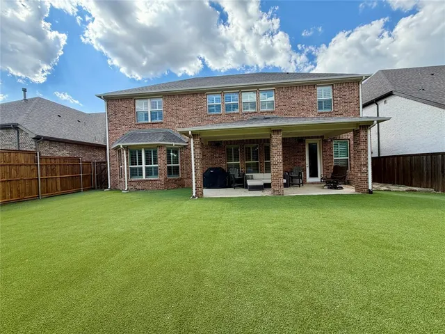 a view of a house with backyard and porch