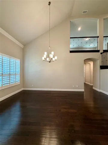 a view of a livingroom with a fireplace wooden floor and windows
