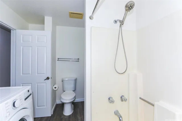 a bathroom with a granite countertop shower and a toilet