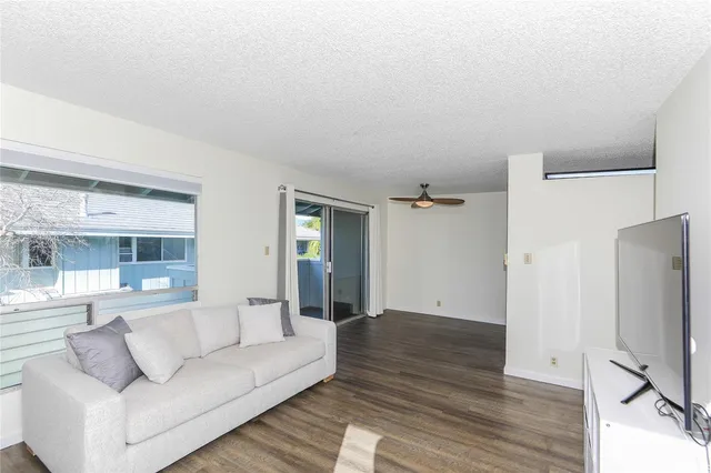 a living room with furniture window and wooden floor