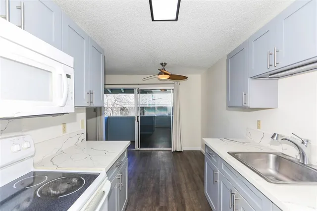 a kitchen with a sink stove and cabinets