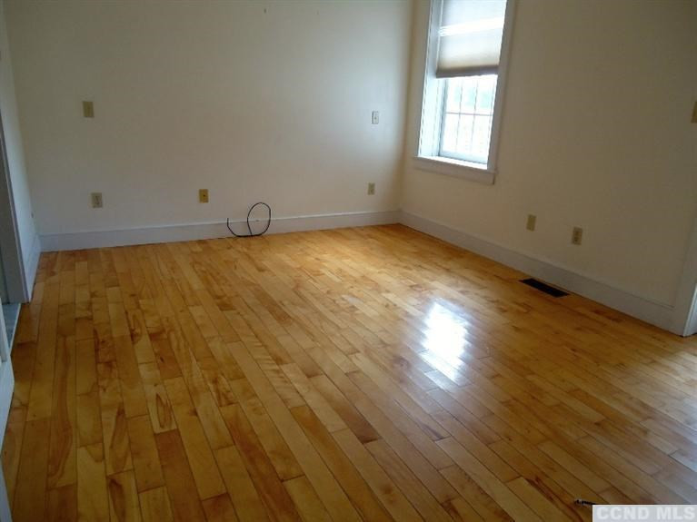 974 Old Post Road Kinderhook, NY 12106 - Photo 7 of 10 an empty room with wooden floor and windows