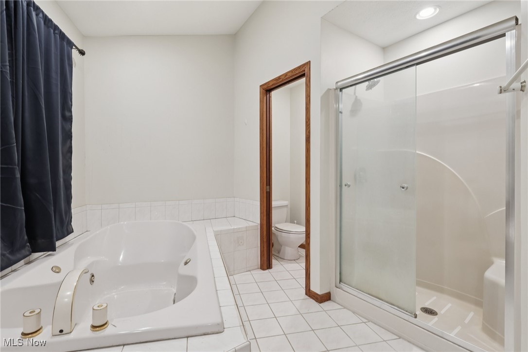 5643 Chapin Road Madison, OH 44057 - Photo 21 of 50 Full bath with a stall shower, a jetted tub, and tile patterned flooring