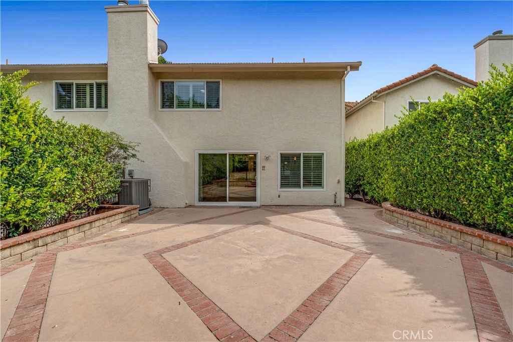 19451 Eagle Ridge Lane Porter Ranch, CA 91326 - Photo 47 of 59 a view of a house with a yard and potted plants