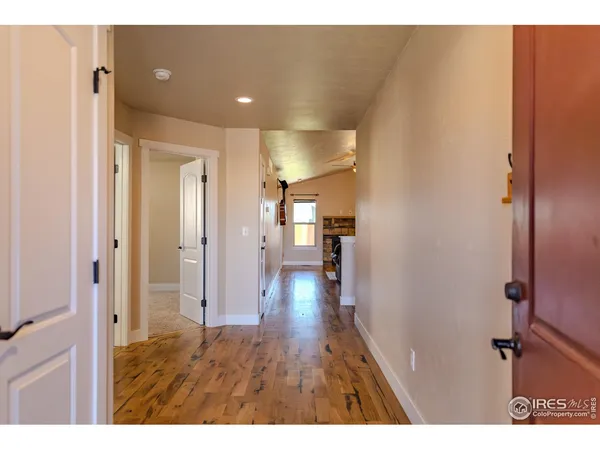 a view of hallway with wooden floor