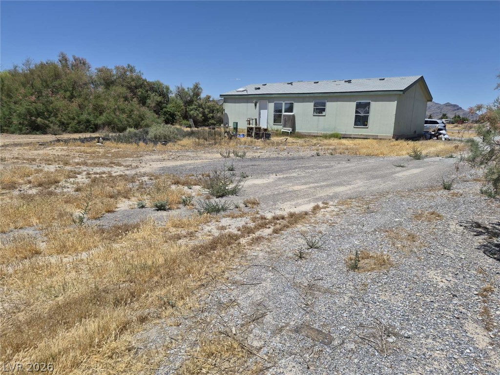 2271 Tough Boy Road Pahrump, NV 89060 - Photo 2 of 12 A spacious lot featuring a single-story residence and distant mountain views.