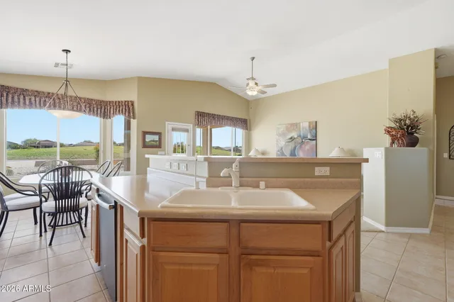 a kitchen with a sink and chairs