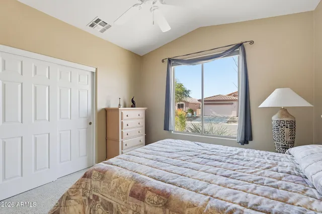 a bedroom with a bed and a window