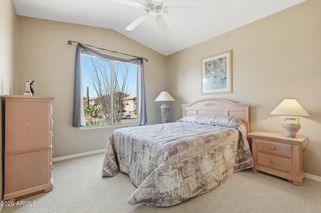 a spacious bedroom with a bed and a large window