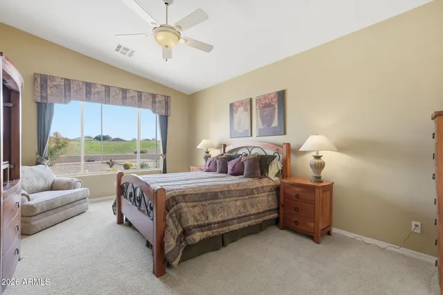 a bedroom with bed and window