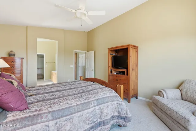 a bedroom with bed and paintings on the wall