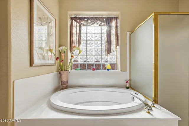 a bathroom with a granite countertop shower and a sink