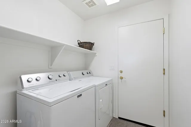 a view of a yard with plants and trees