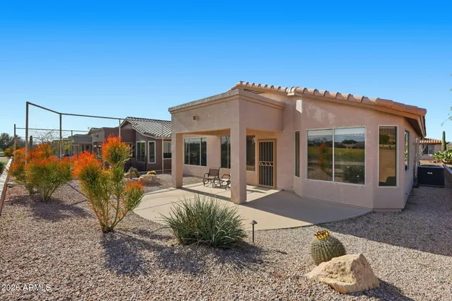 an aerial view of a house with garden space and ocean view