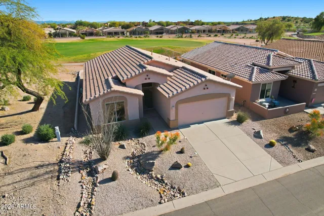 an aerial view of a house with swimming pool and furniture
