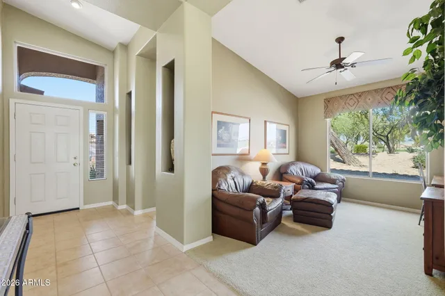 a living room with furniture and a large window