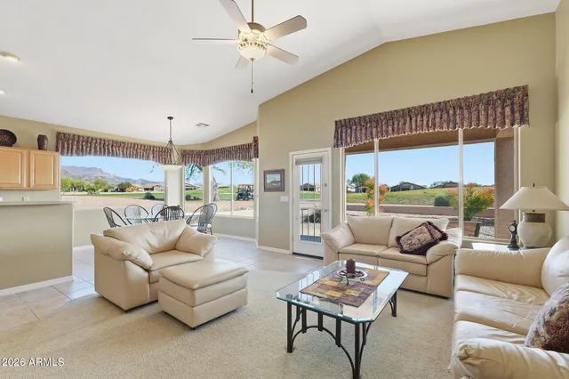 a living room with furniture a chandelier and a fireplace