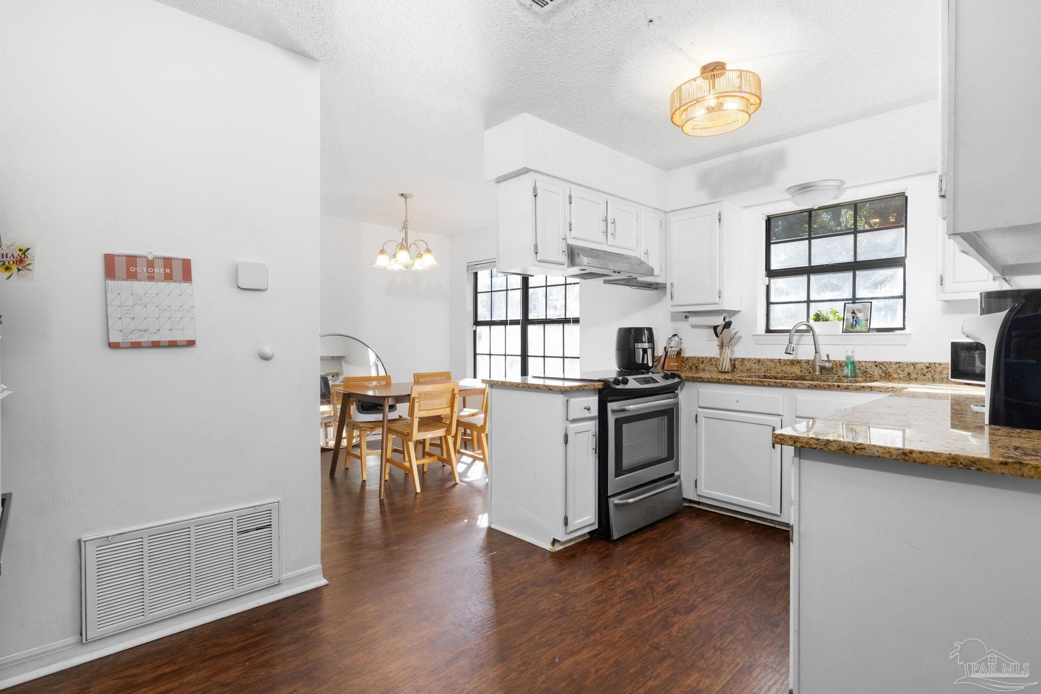 121 Claire Drive Crestview, FL 32536 - Photo 11 of 45 a kitchen with a refrigerator and a stove top oven