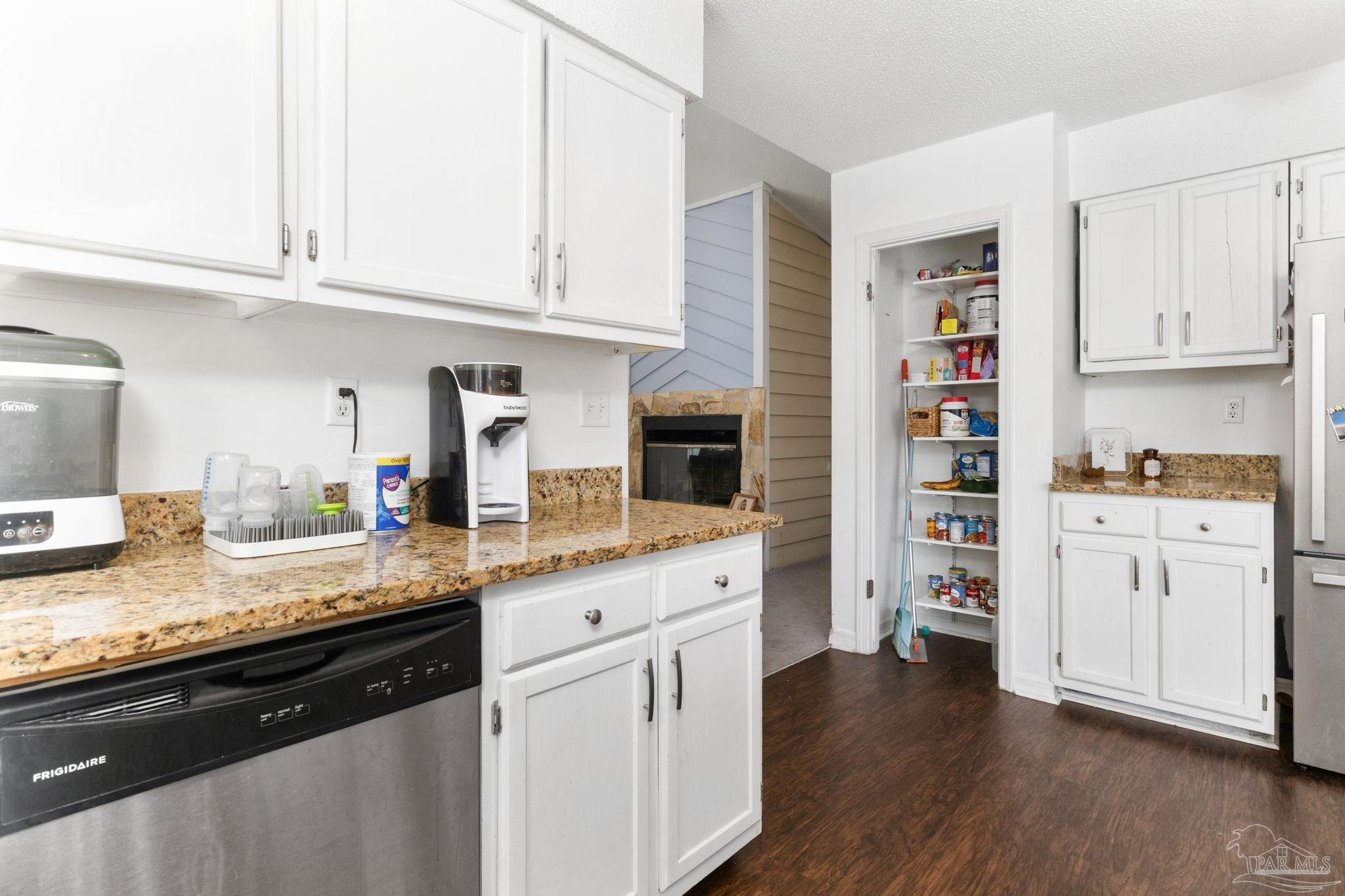 121 Claire Drive Crestview, FL 32536 - Photo 14 of 45 a kitchen with granite countertop cabinets and wooden floor