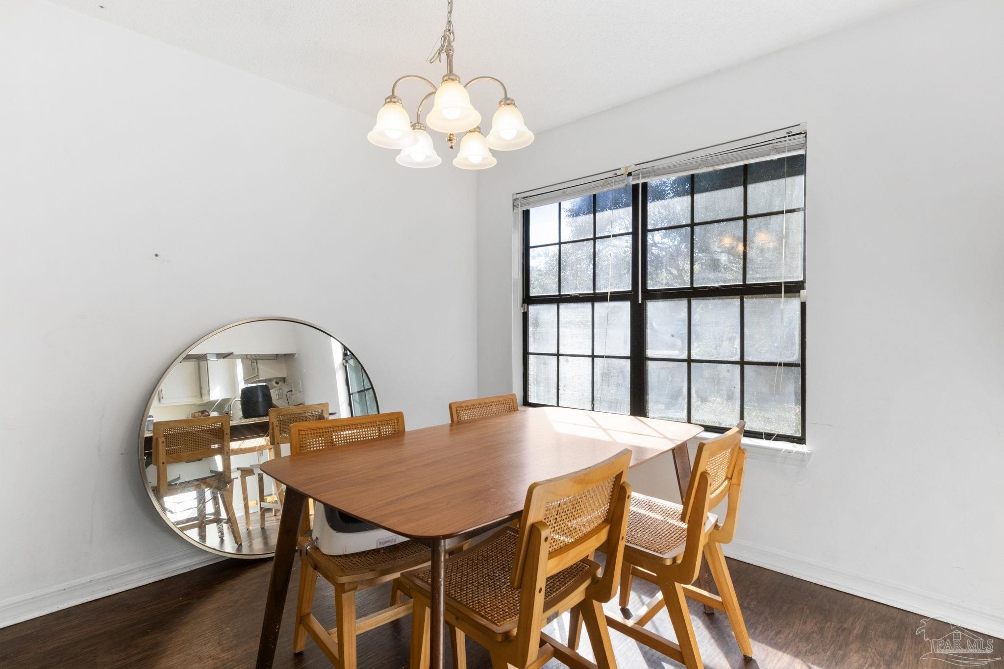 121 Claire Drive Crestview, FL 32536 - Photo 15 of 45 a view of a dining room with furniture and wooden floor
