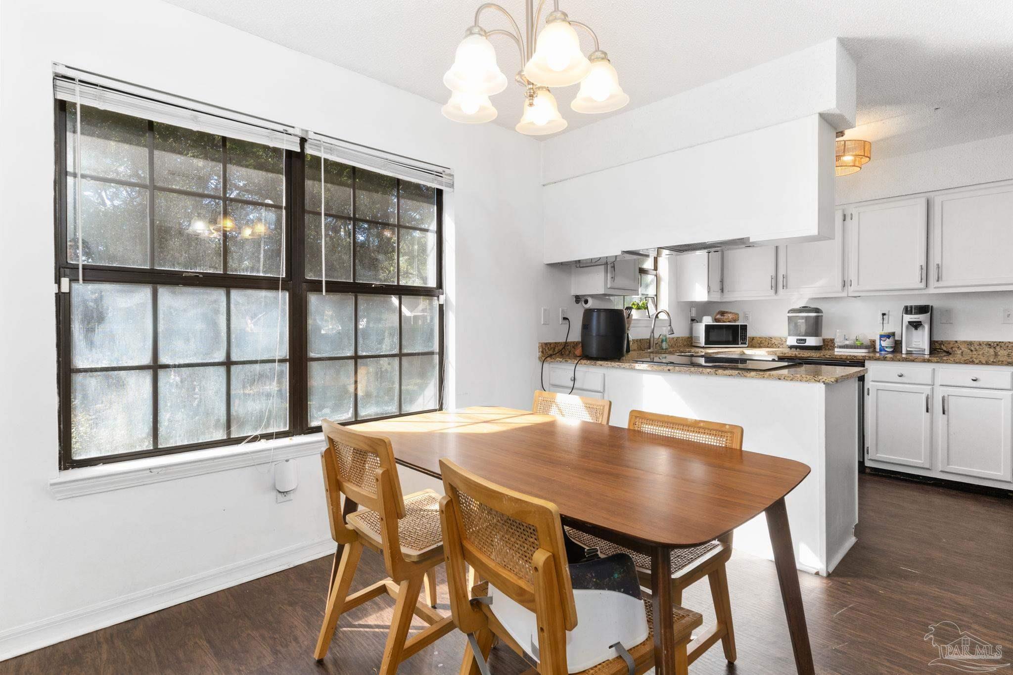 121 Claire Drive Crestview, FL 32536 - Photo 16 of 45 a kitchen with a table chairs sink and cabinets
