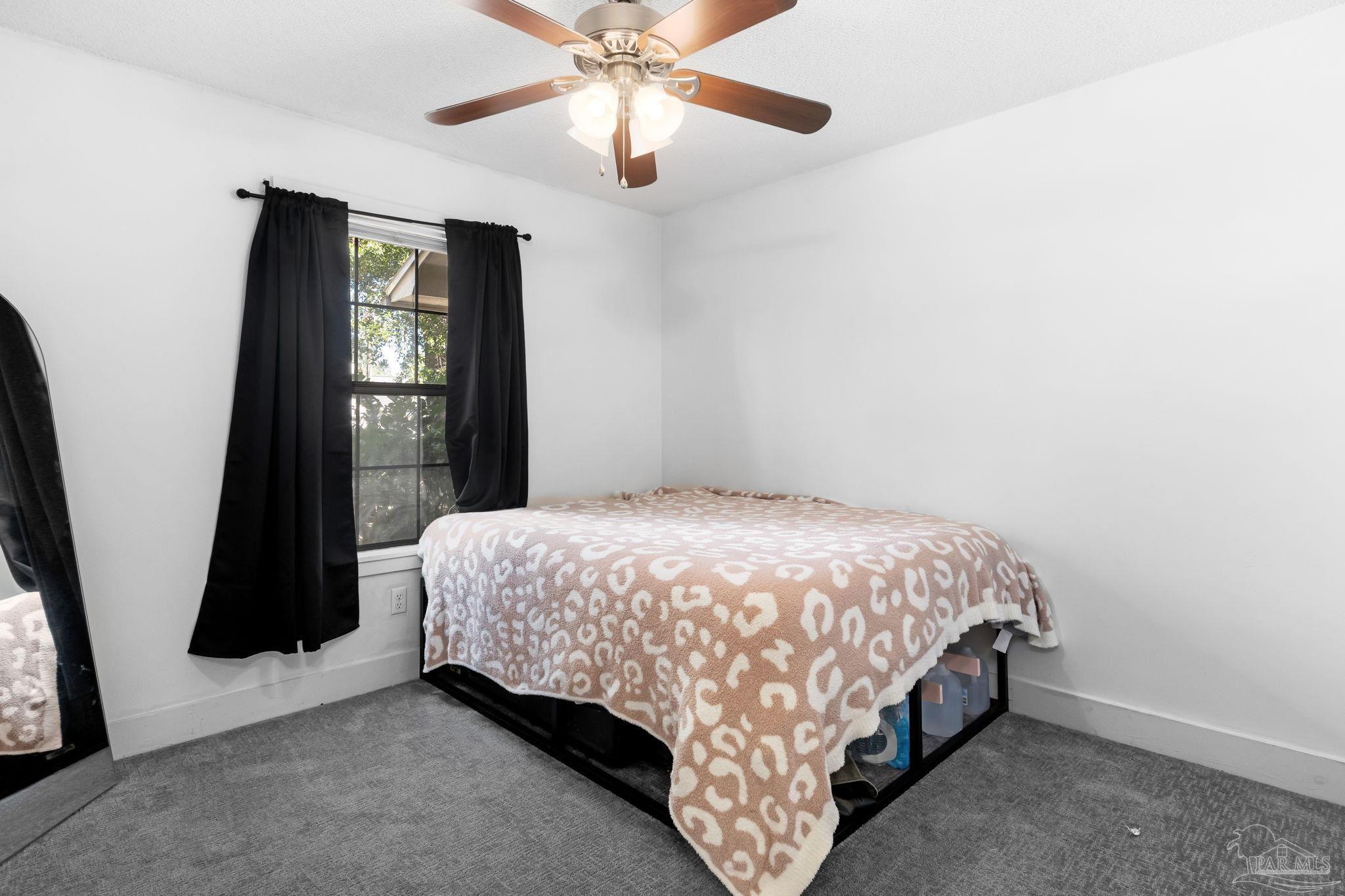 121 Claire Drive Crestview, FL 32536 - Photo 21 of 45 a bed sitting in a bedroom next to a window