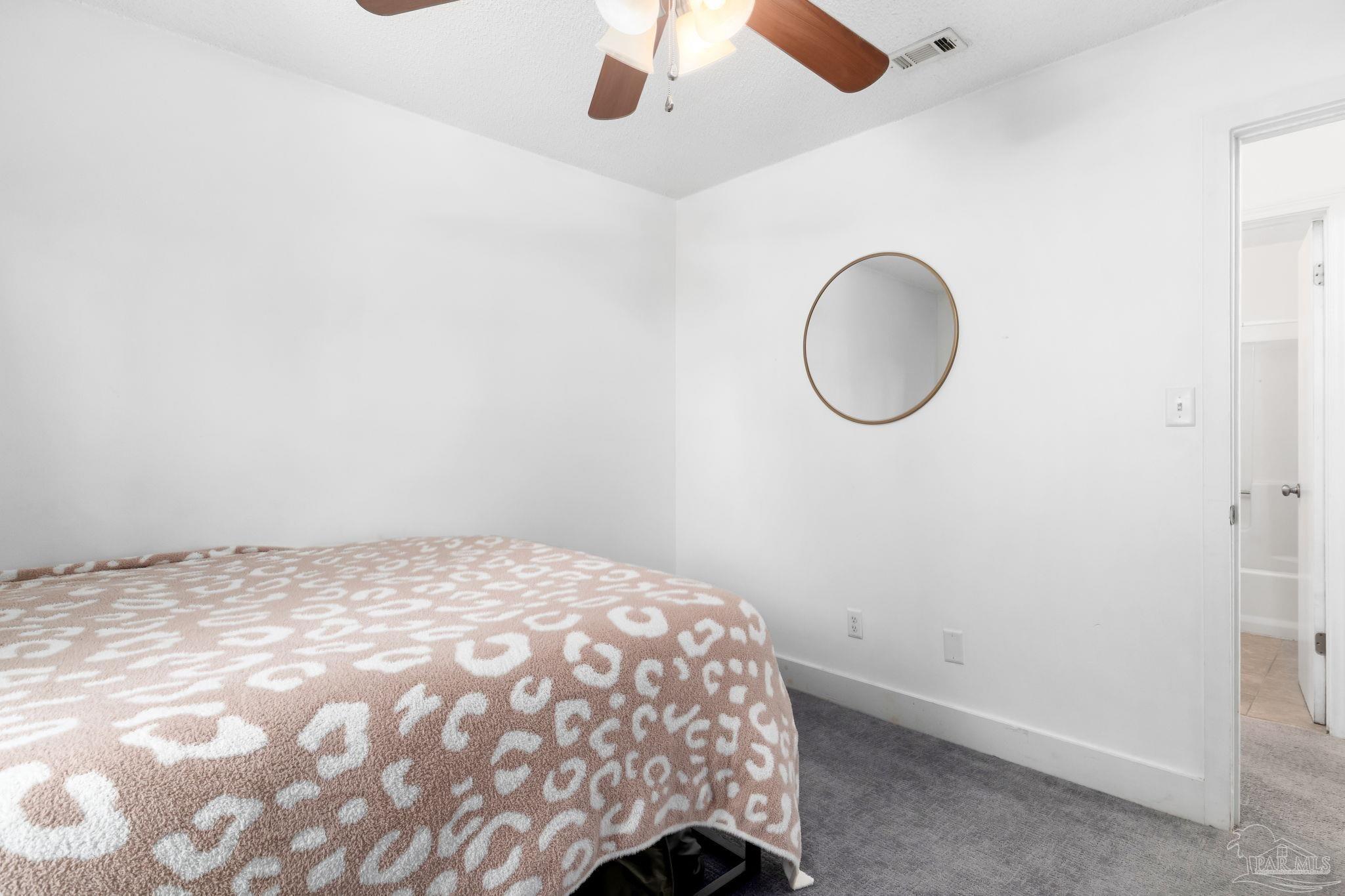 121 Claire Drive Crestview, FL 32536 - Photo 22 of 45 a bedroom with a bed and a chandelier