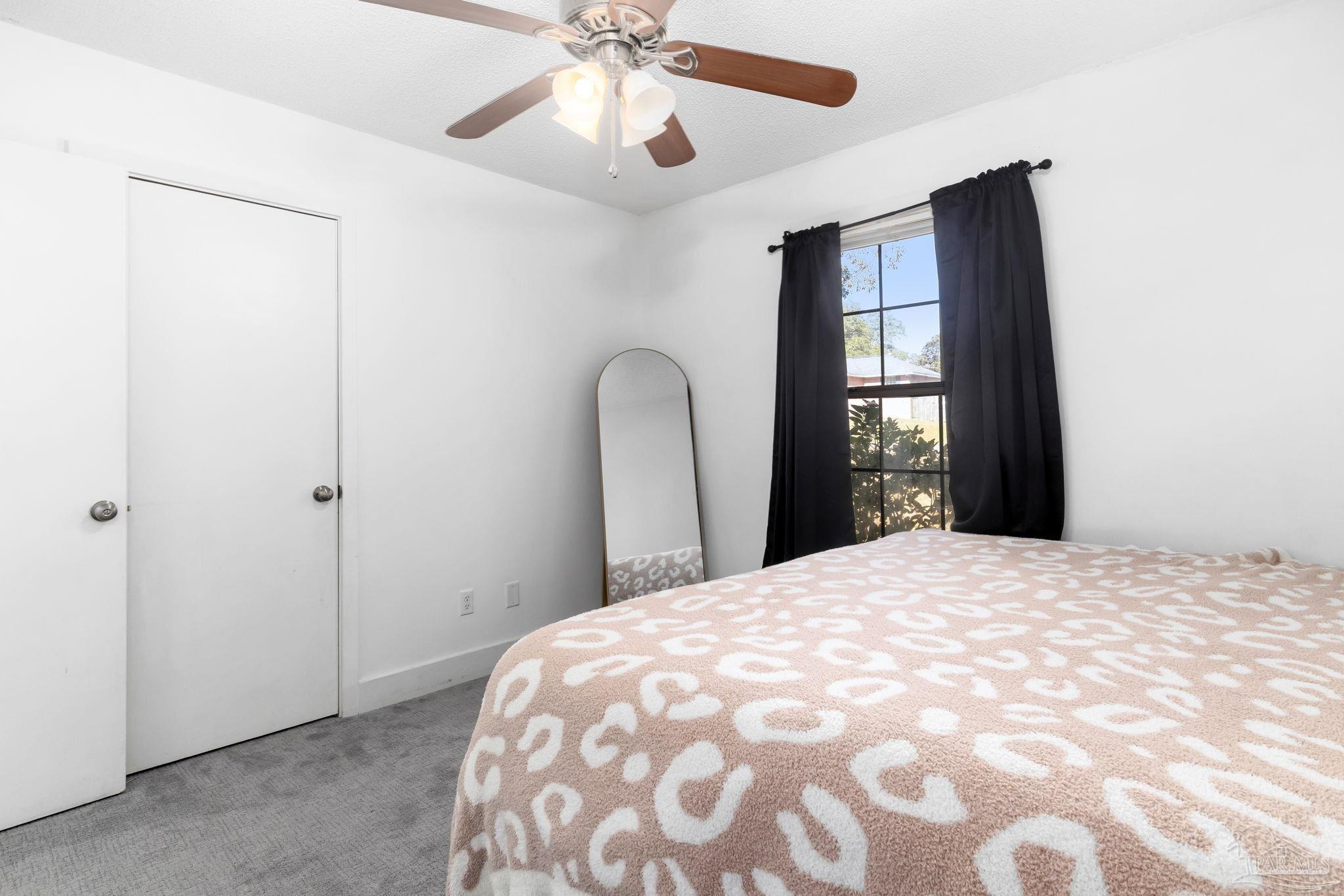 121 Claire Drive Crestview, FL 32536 - Photo 23 of 45 a bedroom with a bed and a chandelier