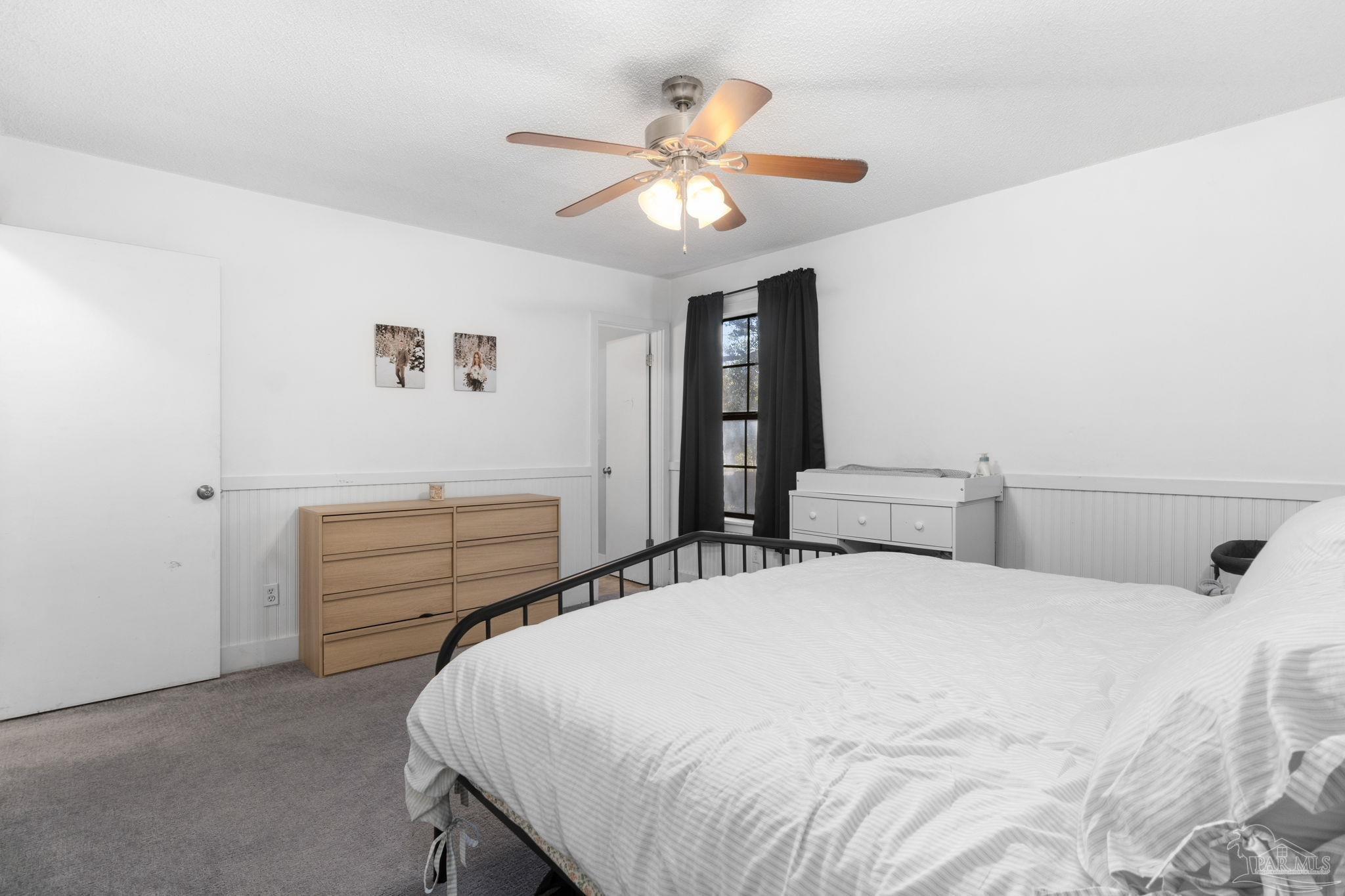 121 Claire Drive Crestview, FL 32536 - Photo 28 of 45 a bedroom with a bed and a chandelier