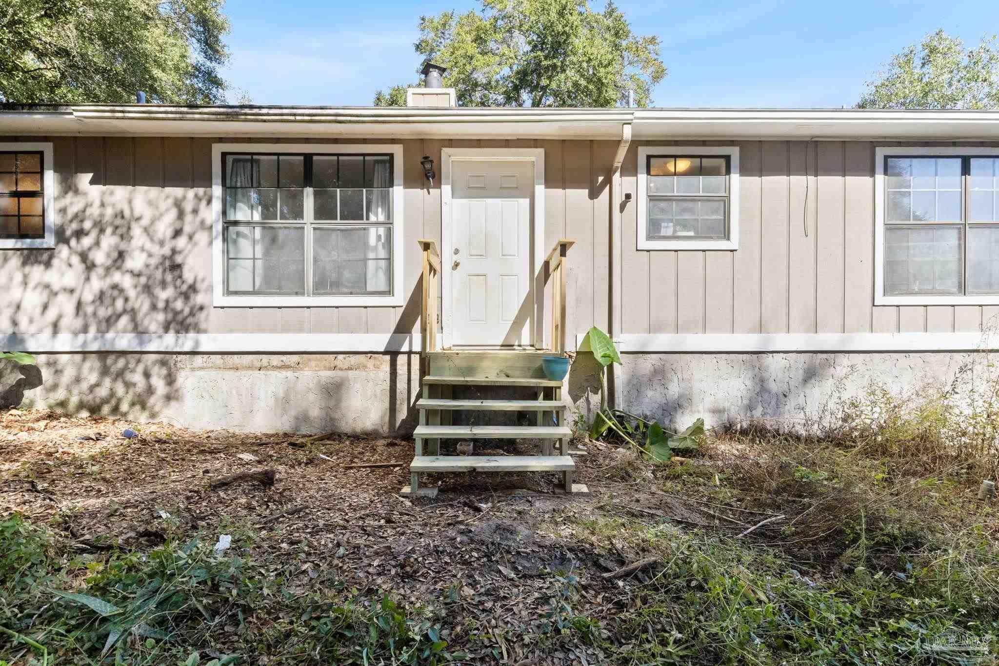121 Claire Drive Crestview, FL 32536 - Photo 35 of 45 a front view of a house with a garden