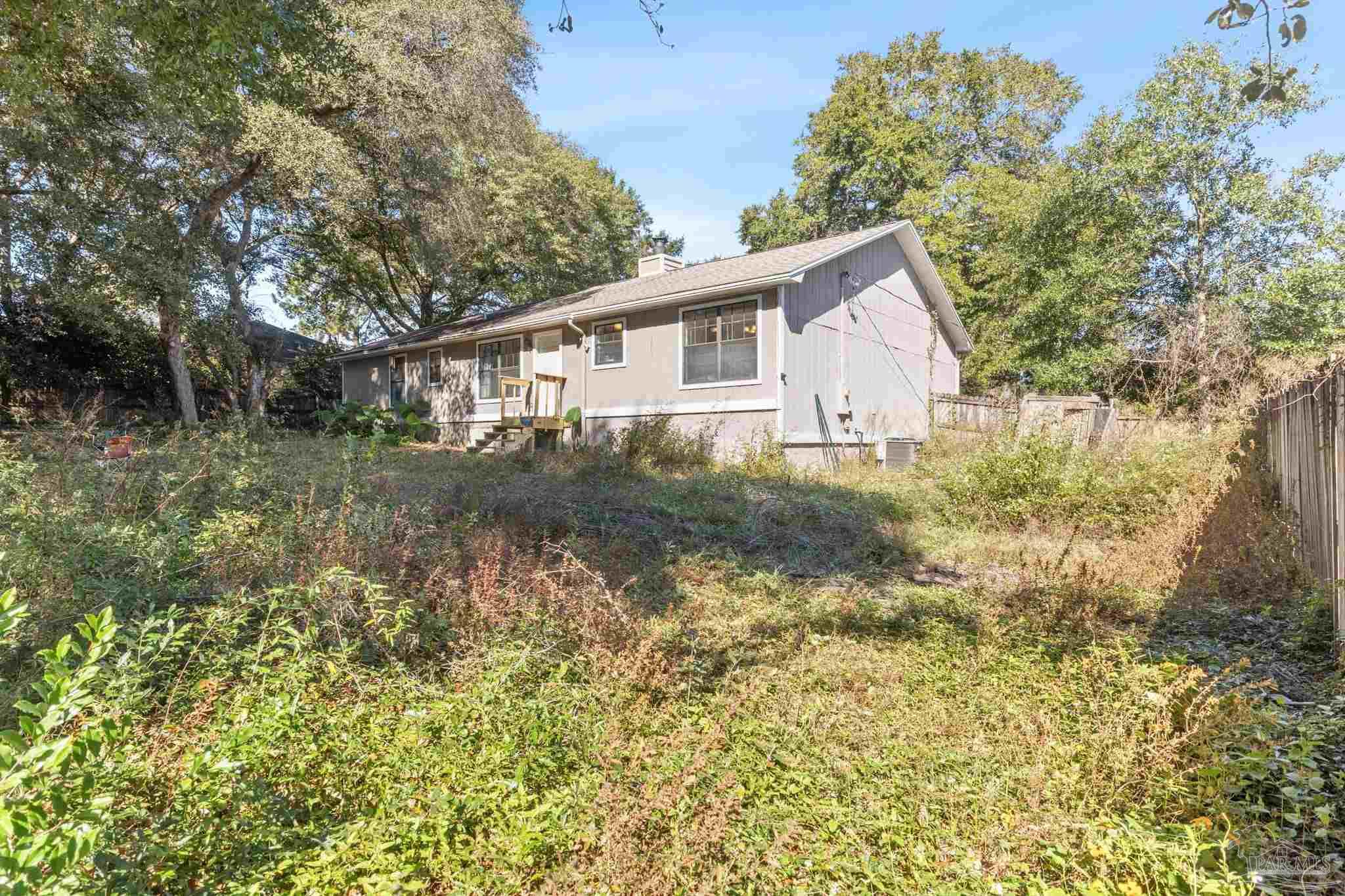 121 Claire Drive Crestview, FL 32536 - Photo 37 of 45 a backyard of a house with plants and large trees
