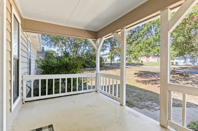 a view of a porch with a floor to ceiling window