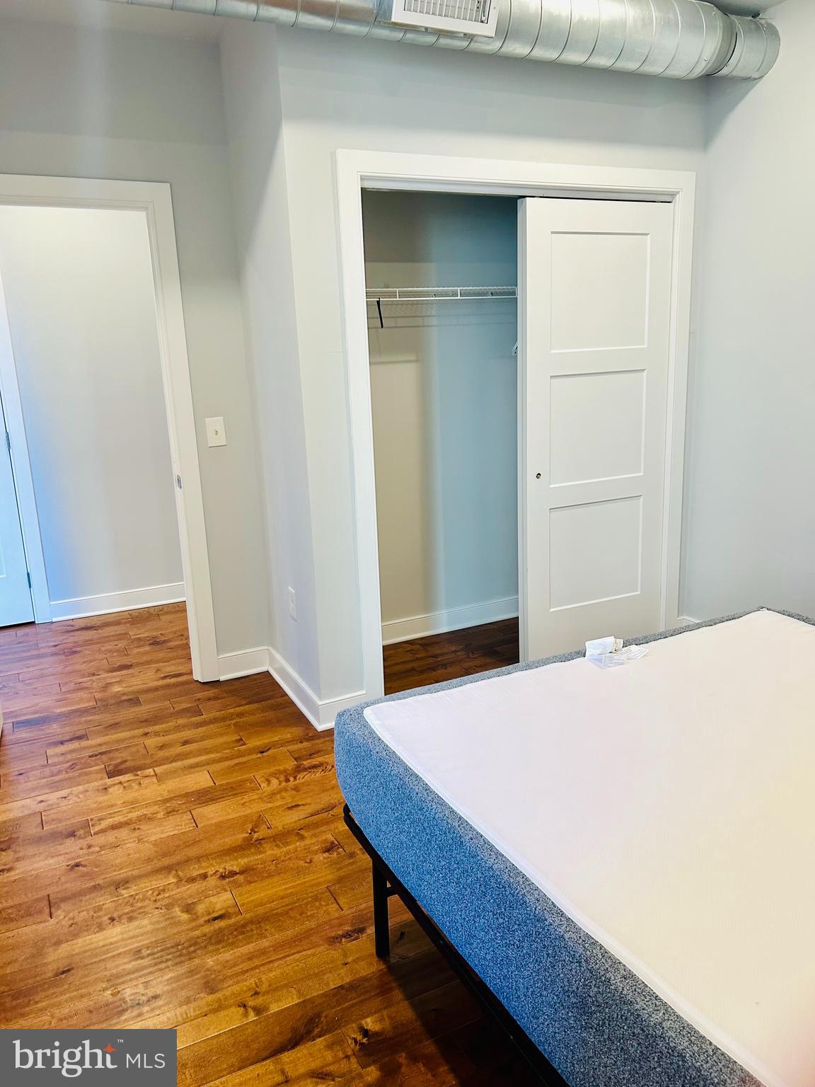 6090 Drexel Road, Unit 1 Philadelphia, PA 19131 - Photo 6 of 9 a bedroom with a bed and wooden floor