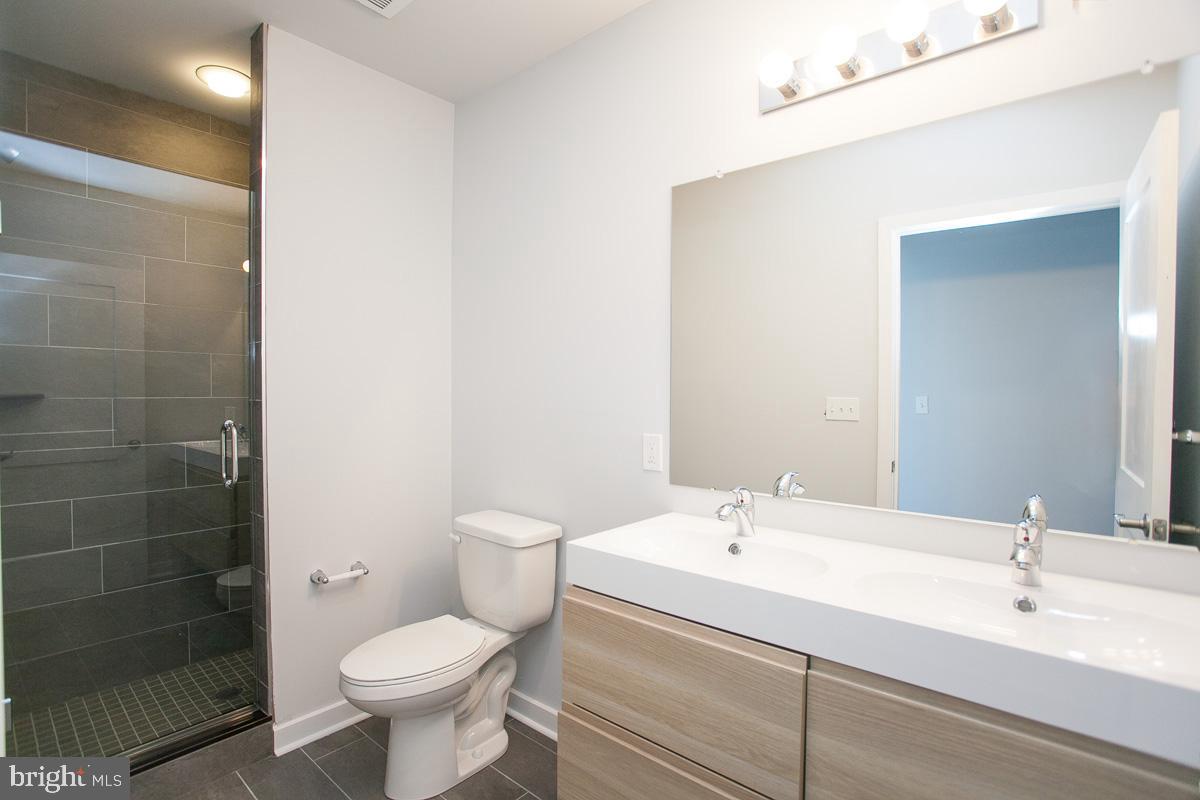 6090 Drexel Road, Unit 1 Philadelphia, PA 19131 - Photo 8 of 9 a bathroom with a sink toilet and shower